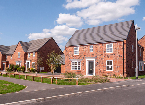 a row of charming red brick houses with modern architecture under a clear blue sky, showcasing well-maintained lawns and a driveway, enhancing residential appeal