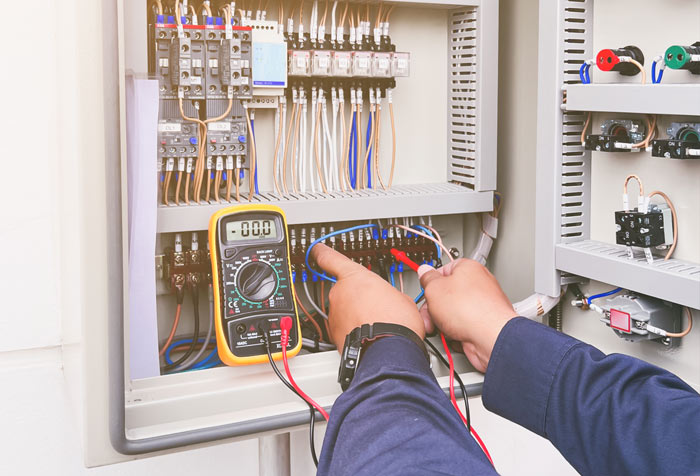 An electrician PAT testing a fuse box